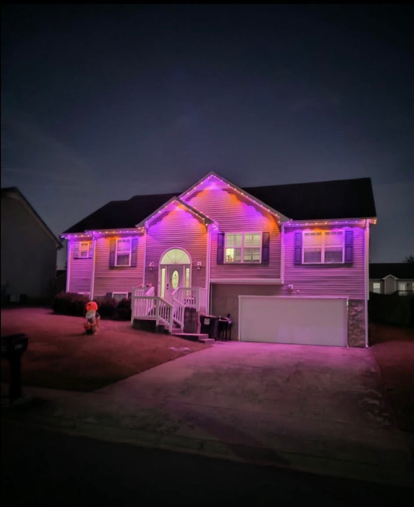 House with vibrant pink and orange permanent LED lighting