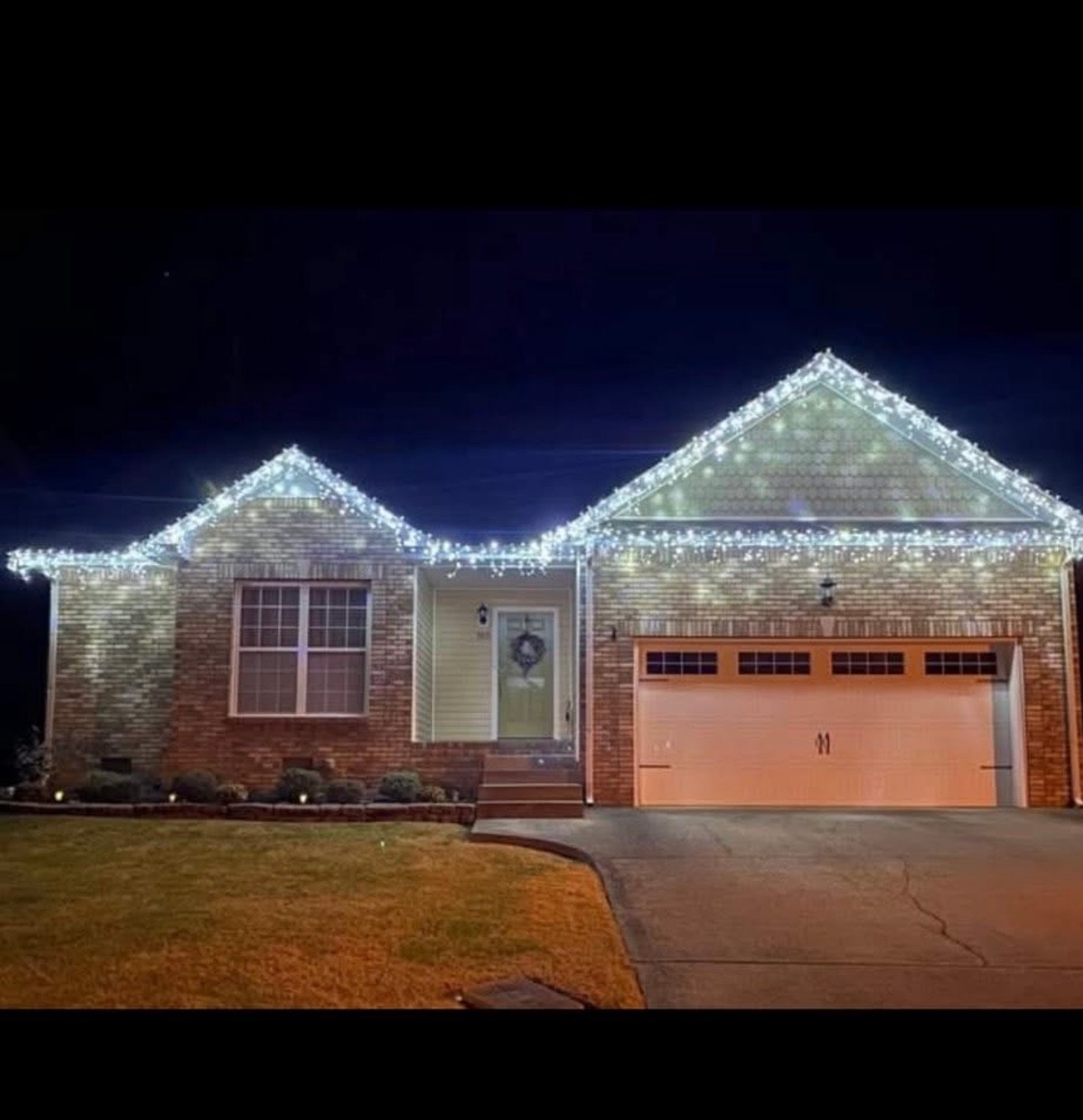 Brick home with bright white icicle Christmas lights